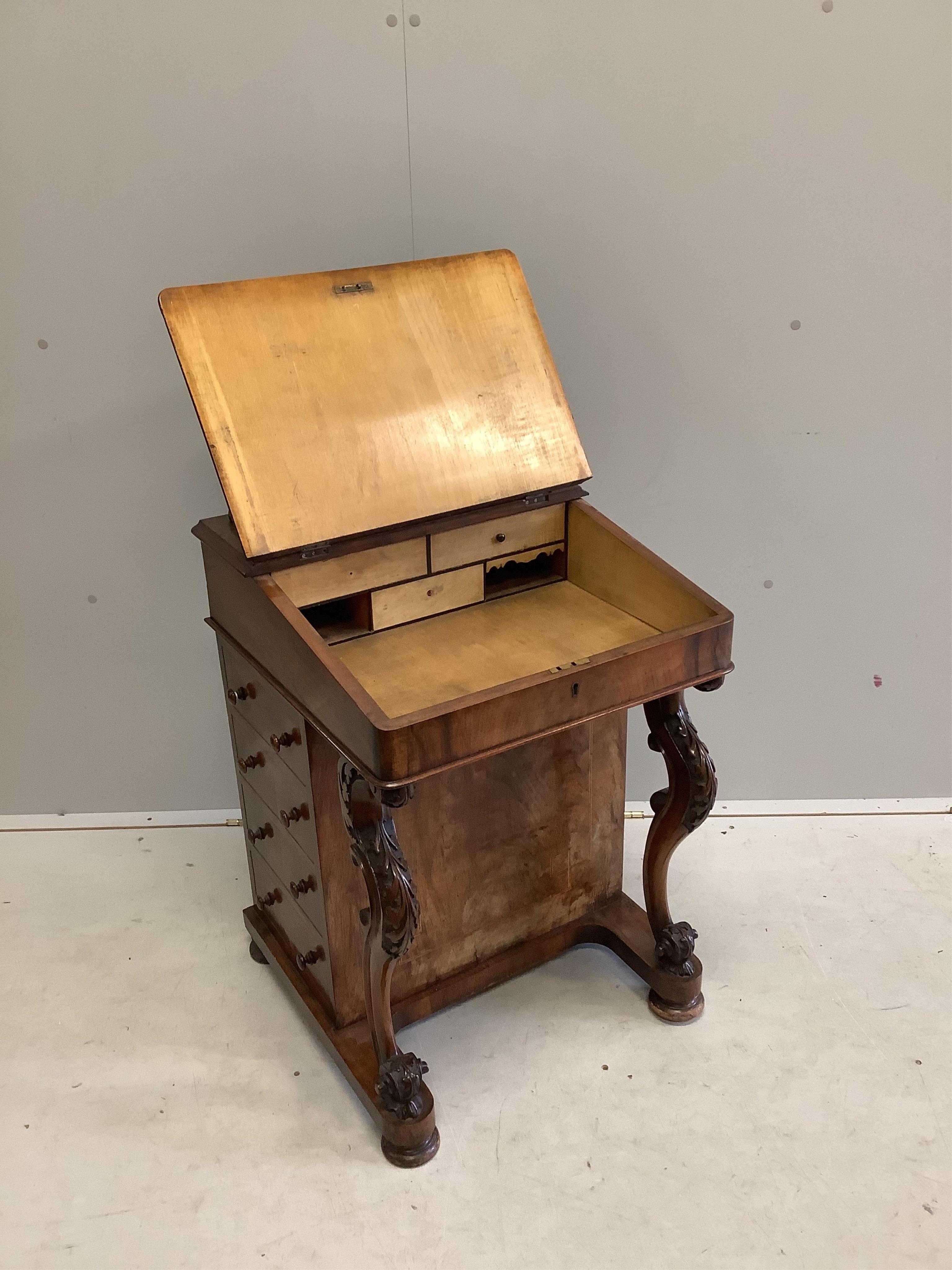 A late Victorian banded figured walnut Davenport, width 54cm, depth 54cm, height 78cm. Condition - fair